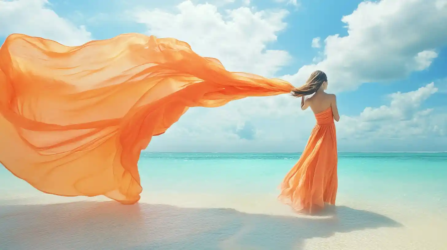 Woman with flowing fabric by turquoise seaside shore