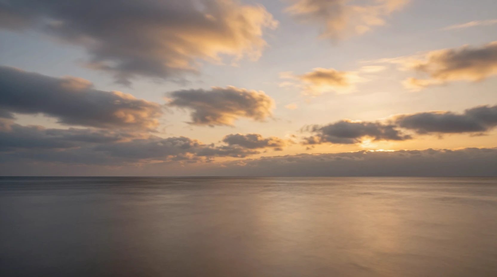 Calm autumn sea at twilight reflecting a glowing sky