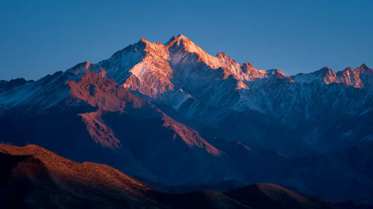 Sunrise over xinjiang mountain range in golden and blue light