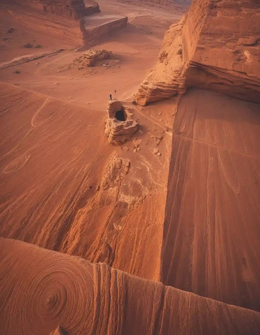 Meditating figure in a vast ancient desert chasma