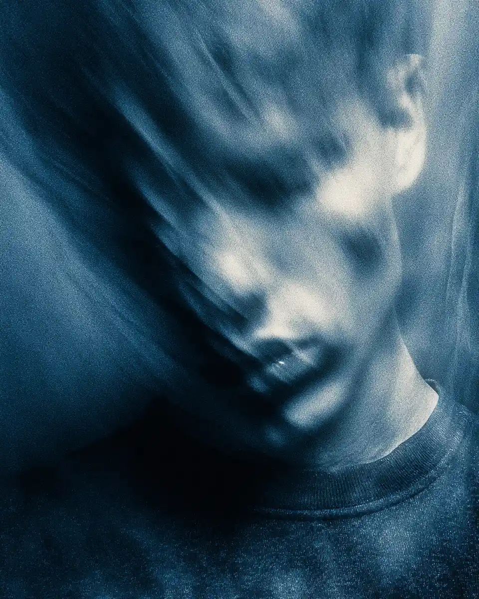 Gritty close up portrait with face half hidden in shadow