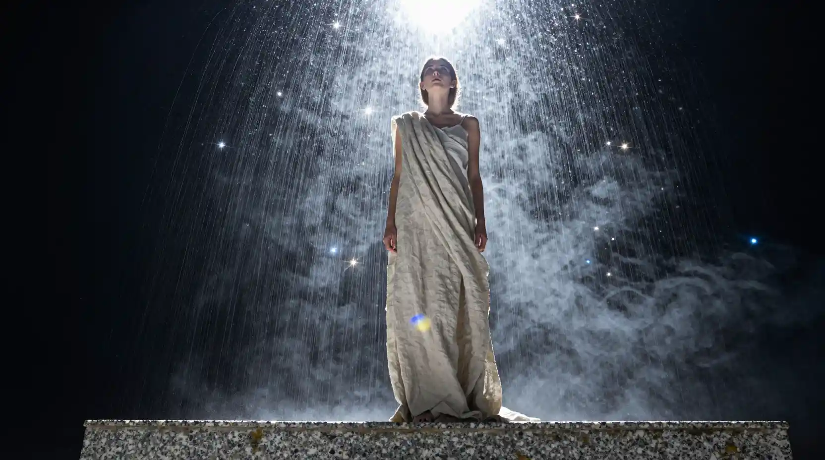 Young woman gazing into cascading starlight from below