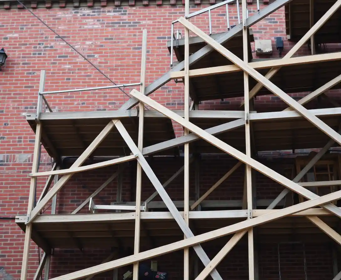 Wooden scaffolding on an old brick building in soft light