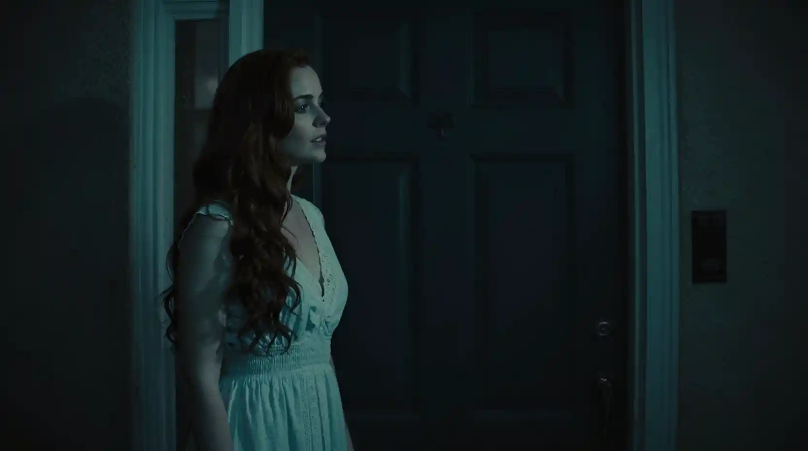 Woman at her front door in bleak cinematic lighting