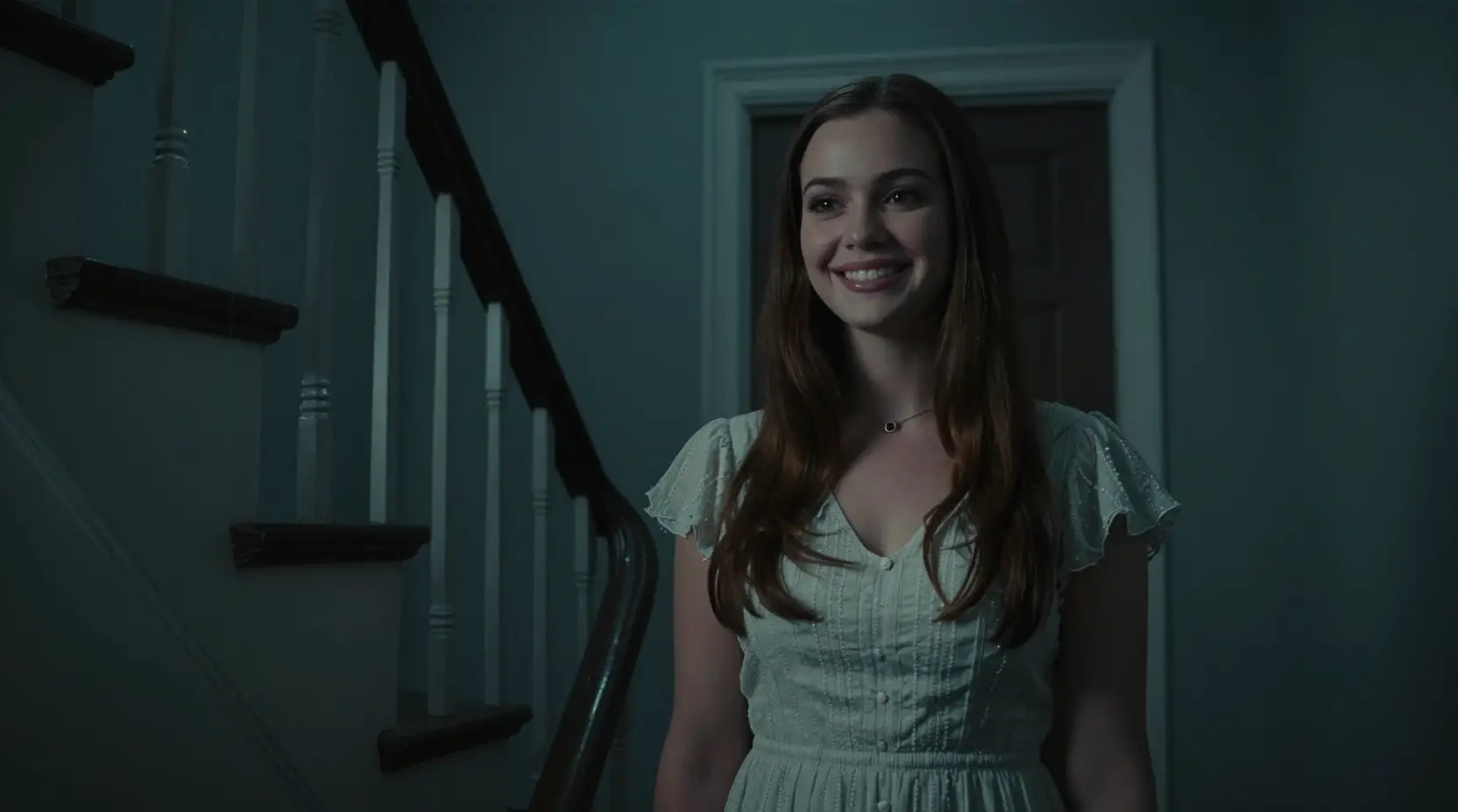 Woman at her front door in a dark cinematic stairwell