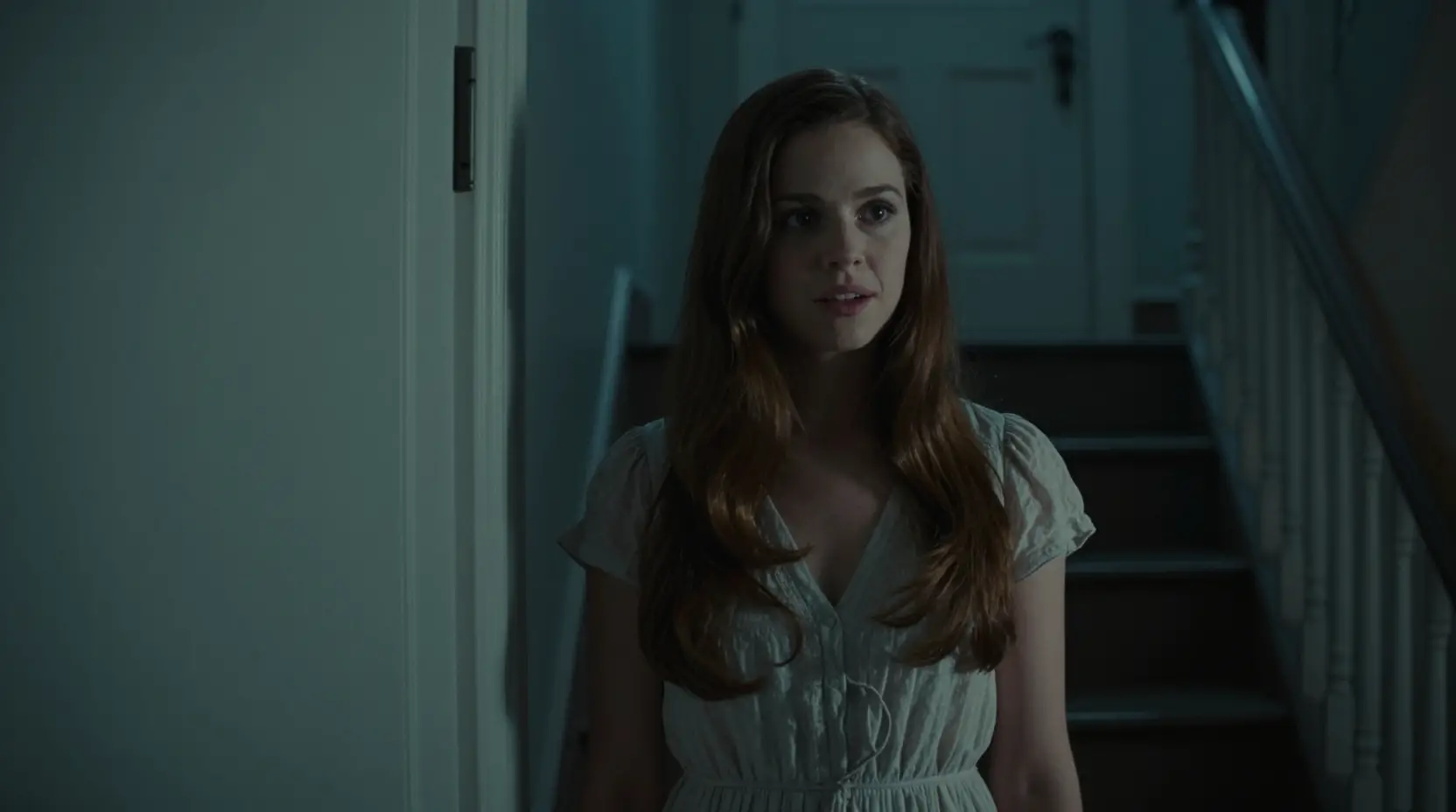 Sweet neighbor standing by her door in dim stairwell