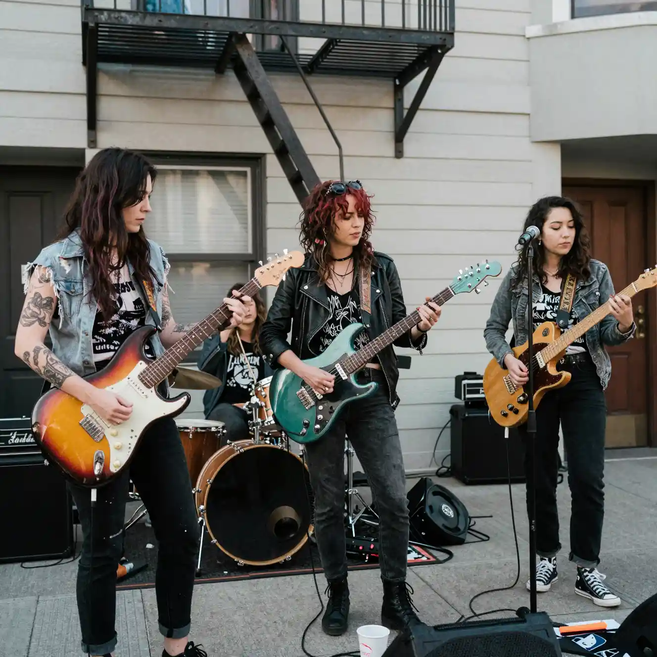 Women grunge band relaxing on a San Francisco fire escape
