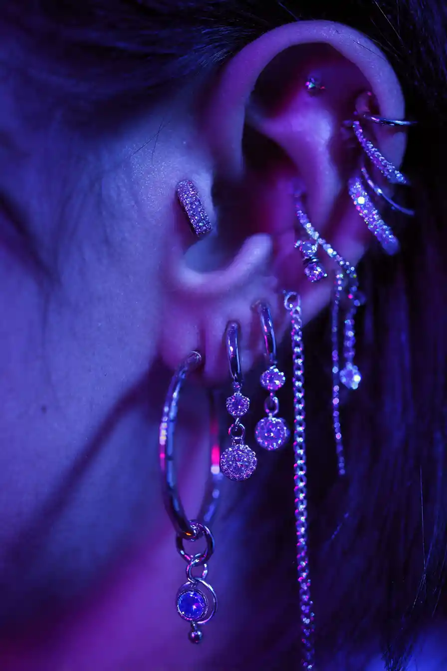 Close up ear with multiple diamond studded piercings