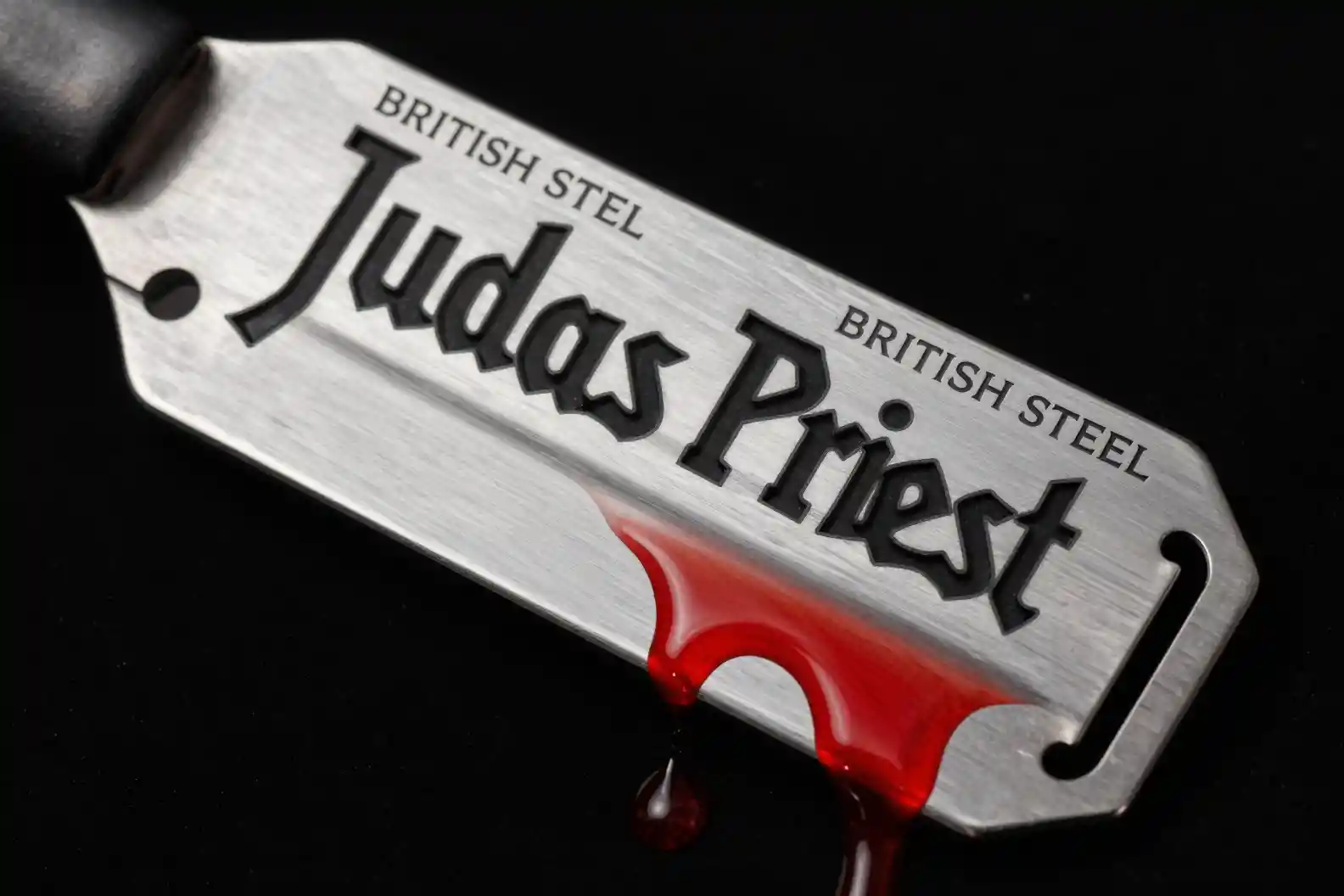 Silver razor blade with blood on black metal cover