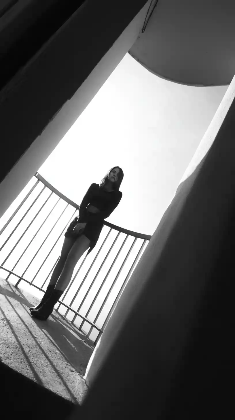 Woman standing on balcony seen from dramatic low angle