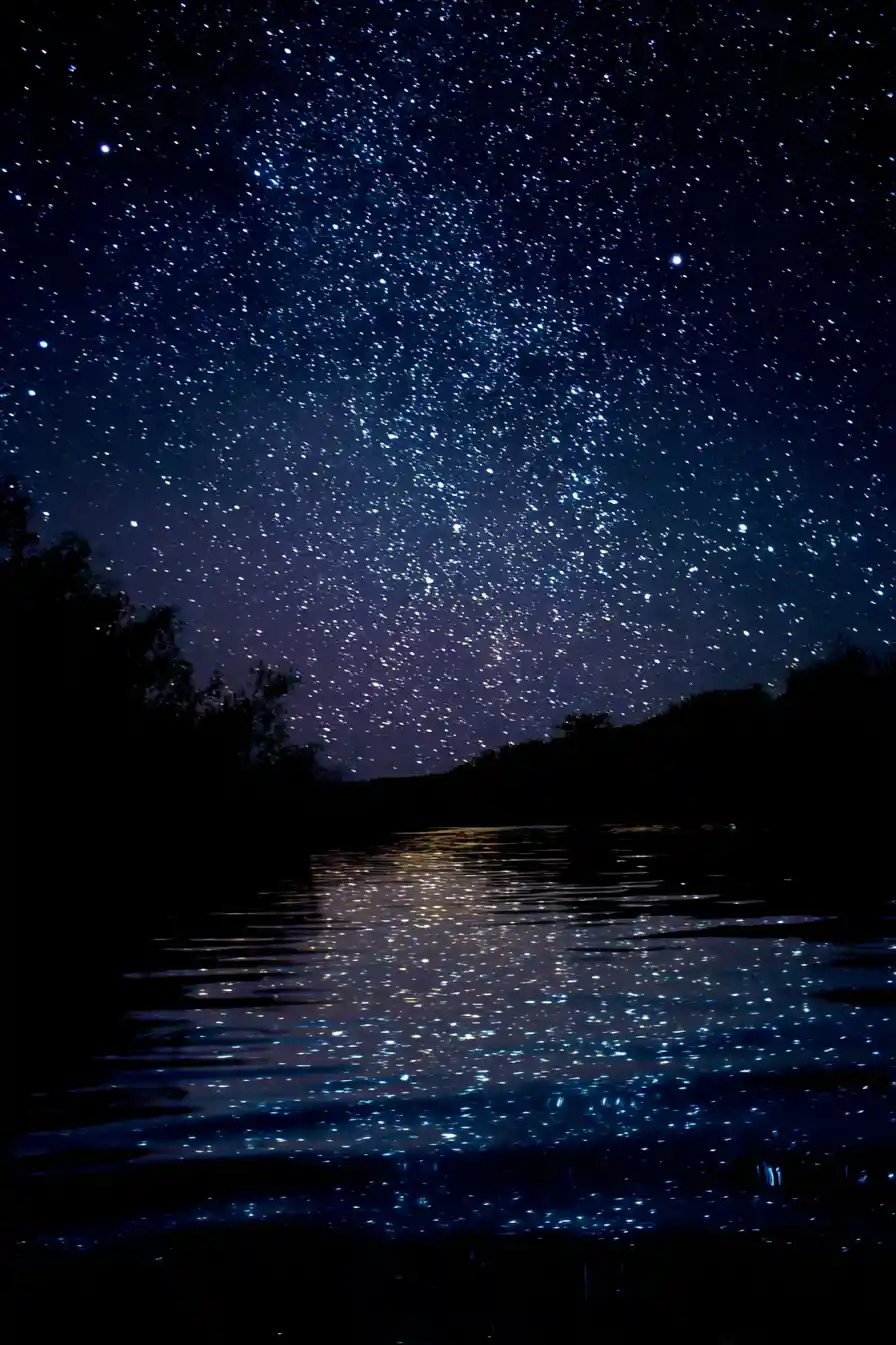 Person gazing at stars reflected on a quiet night river