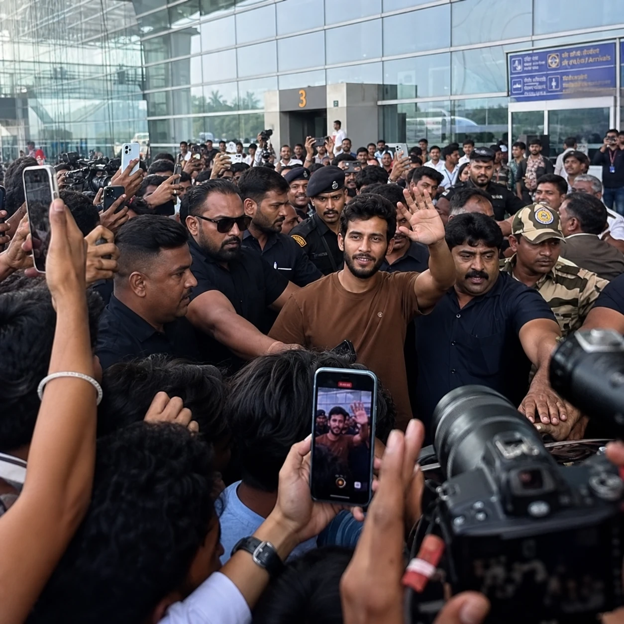 Young celebrity walking through crowded airport arrival gate