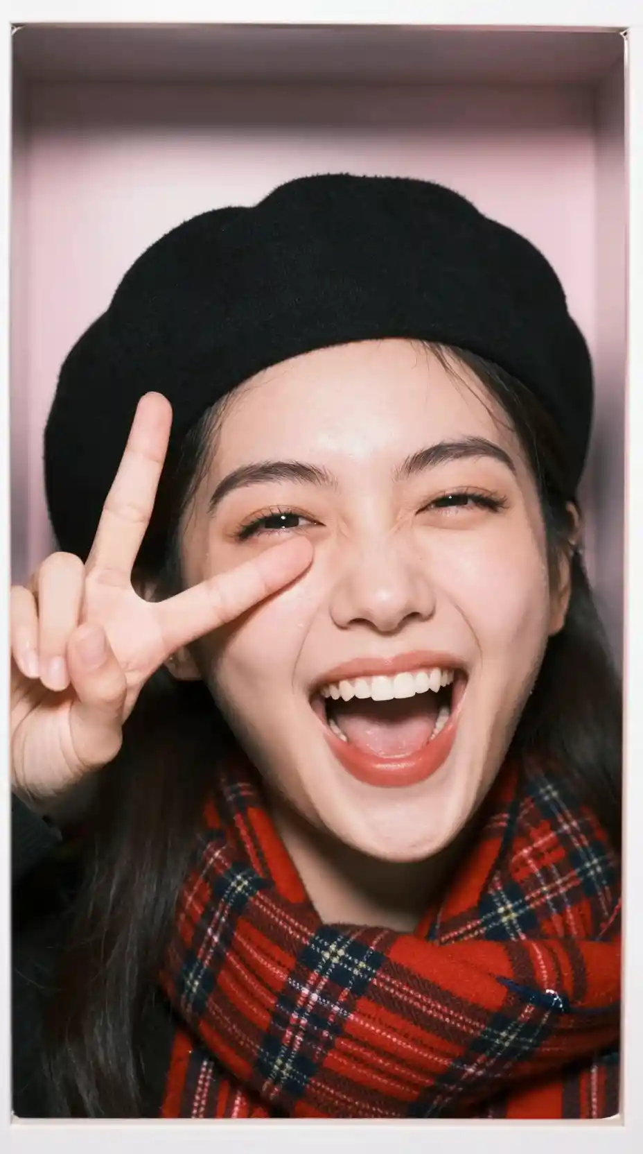 Laughing girl in photo booth extreme close up portrait