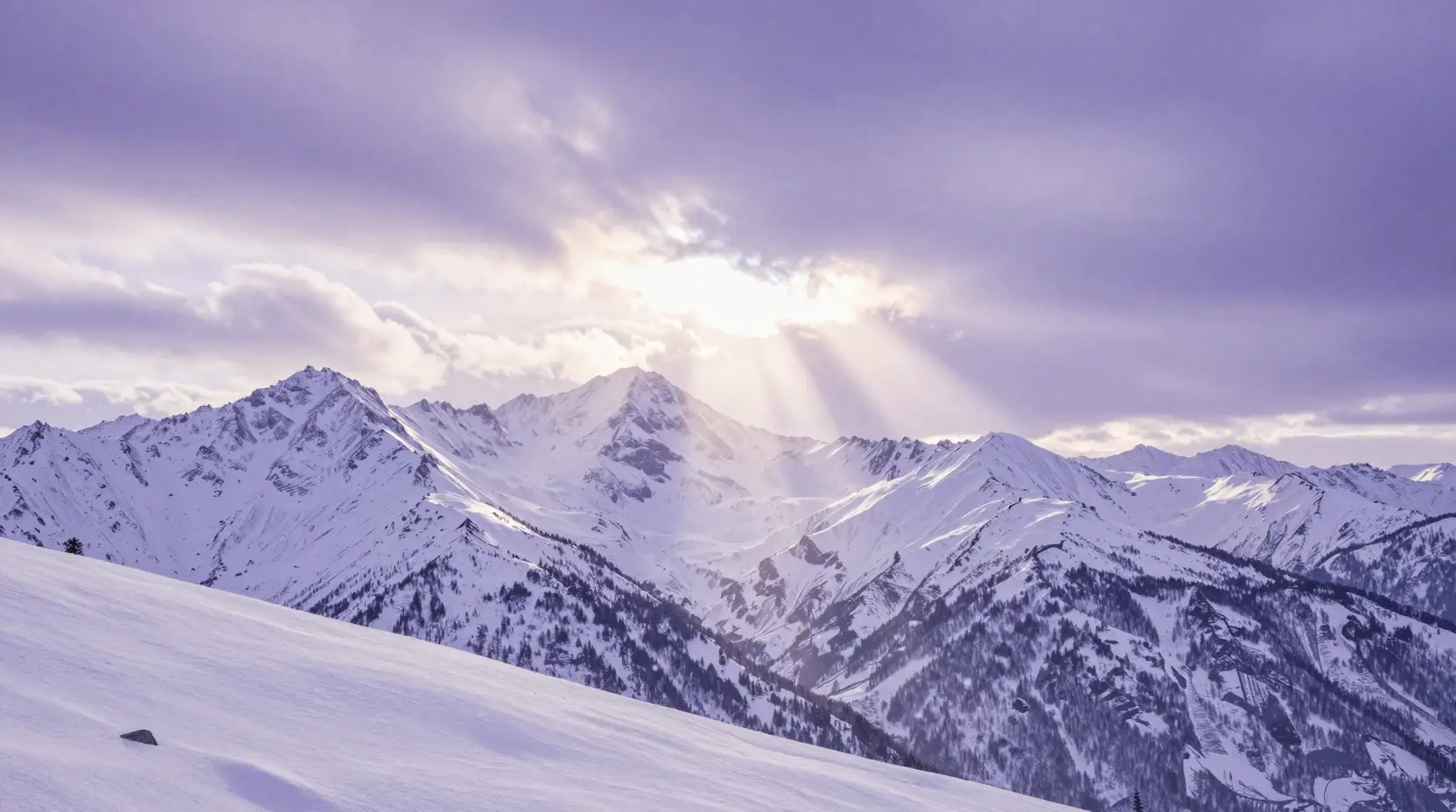 Wide mountain range at dawn with soft moonlit rays
