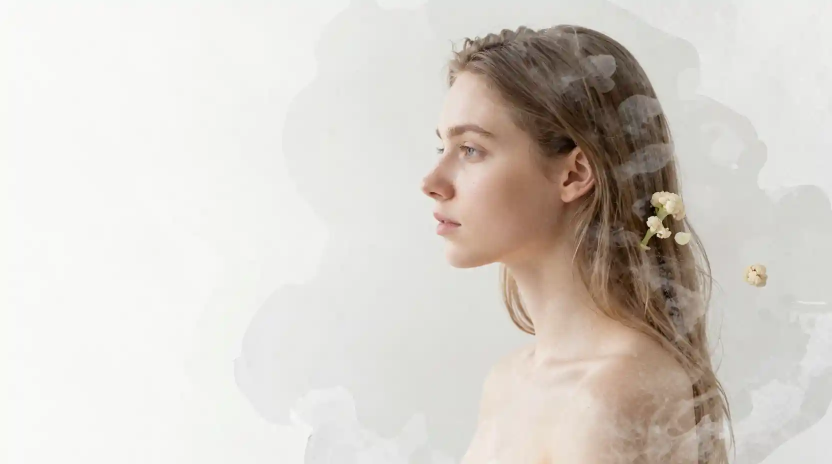 Young woman fading into bright watercolor paper background