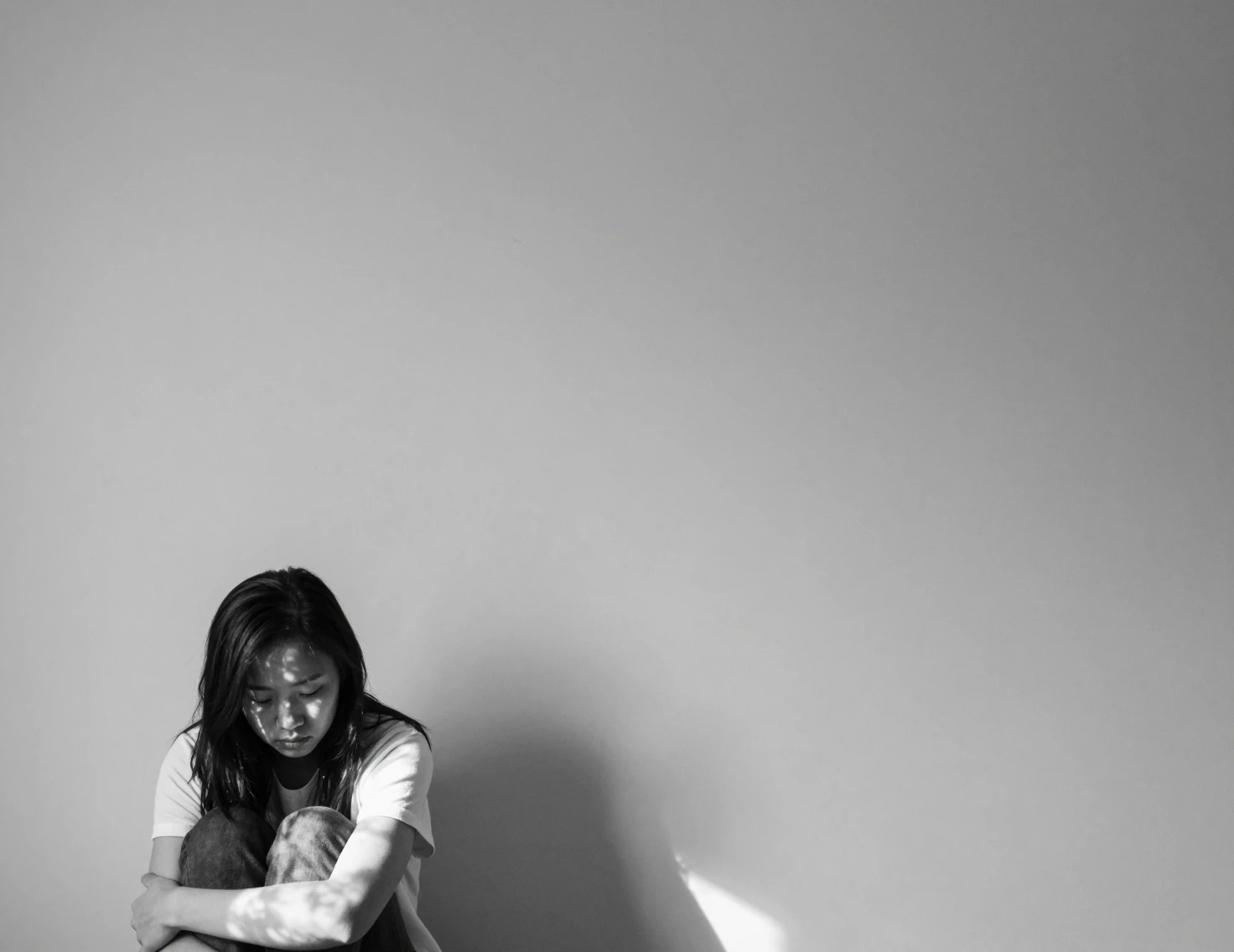 Young woman in black and white with dramatic negative space