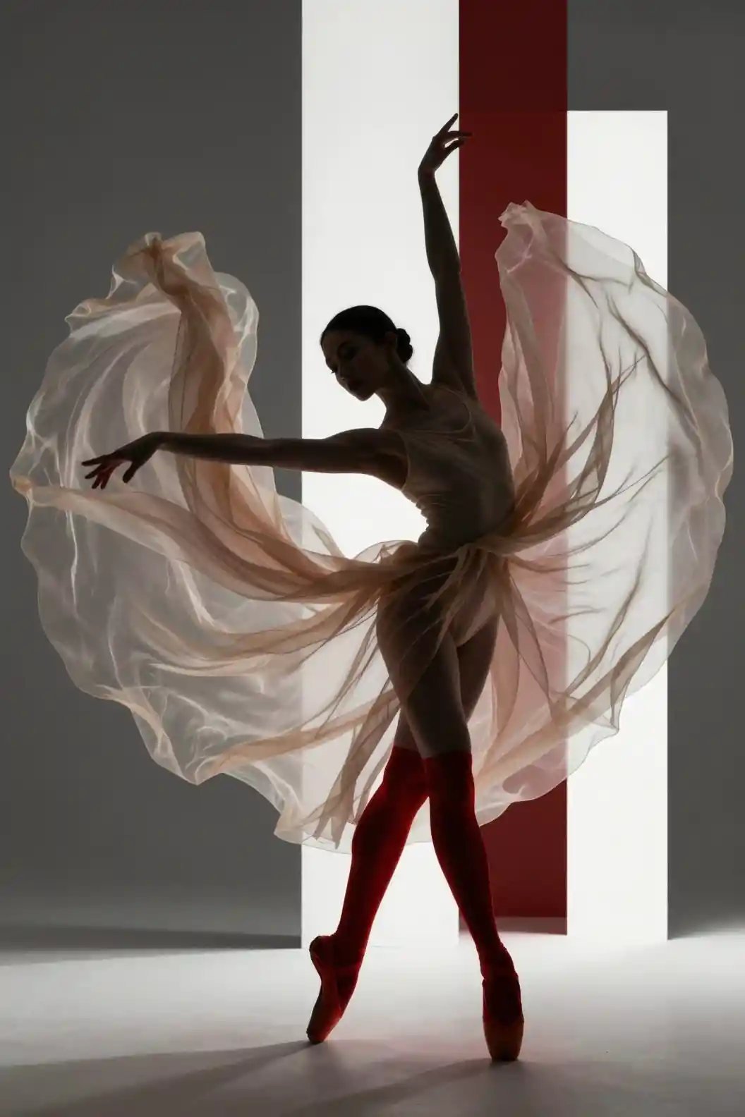 Dynamic ballet dancer in flowing sheer fabric and red shoes