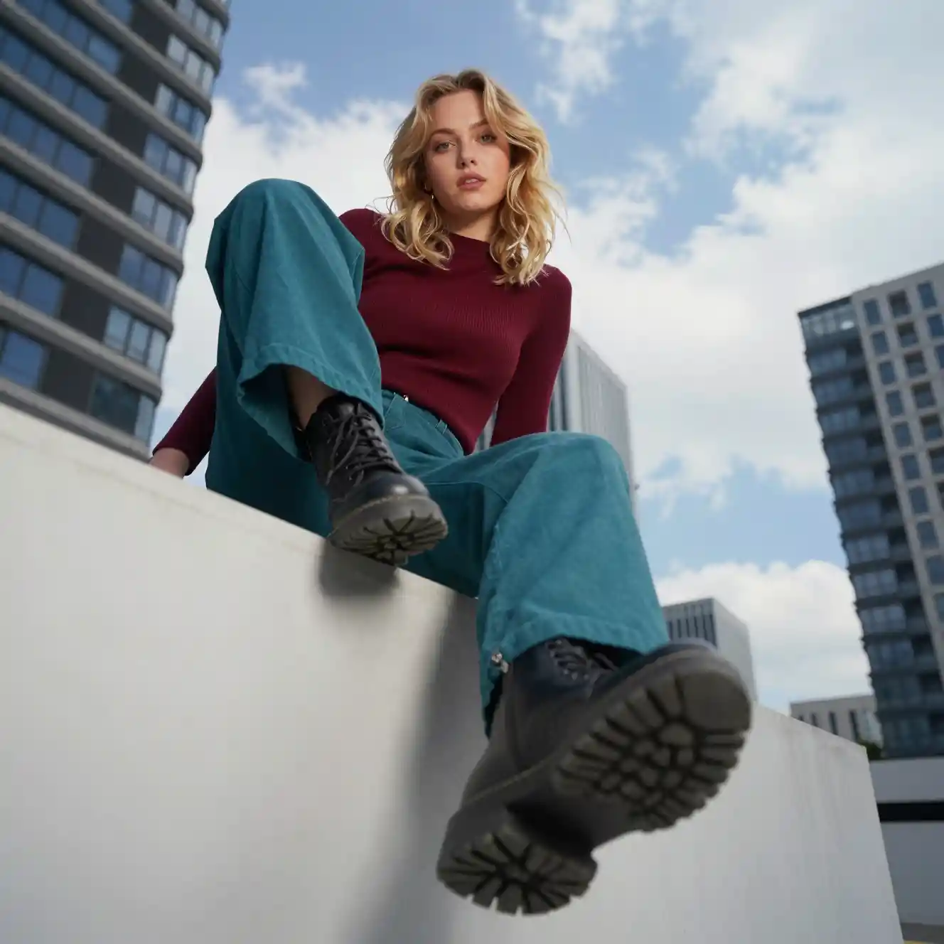 Young woman in cityscape viewed from bold low angle