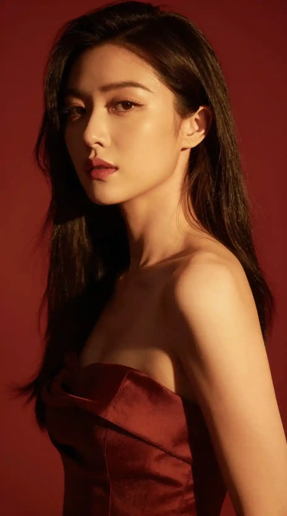 Fashion portrait of a woman in dramatic golden red lighting