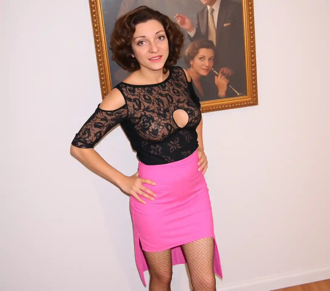 Woman in lace blouse and pink mini skirt with heels