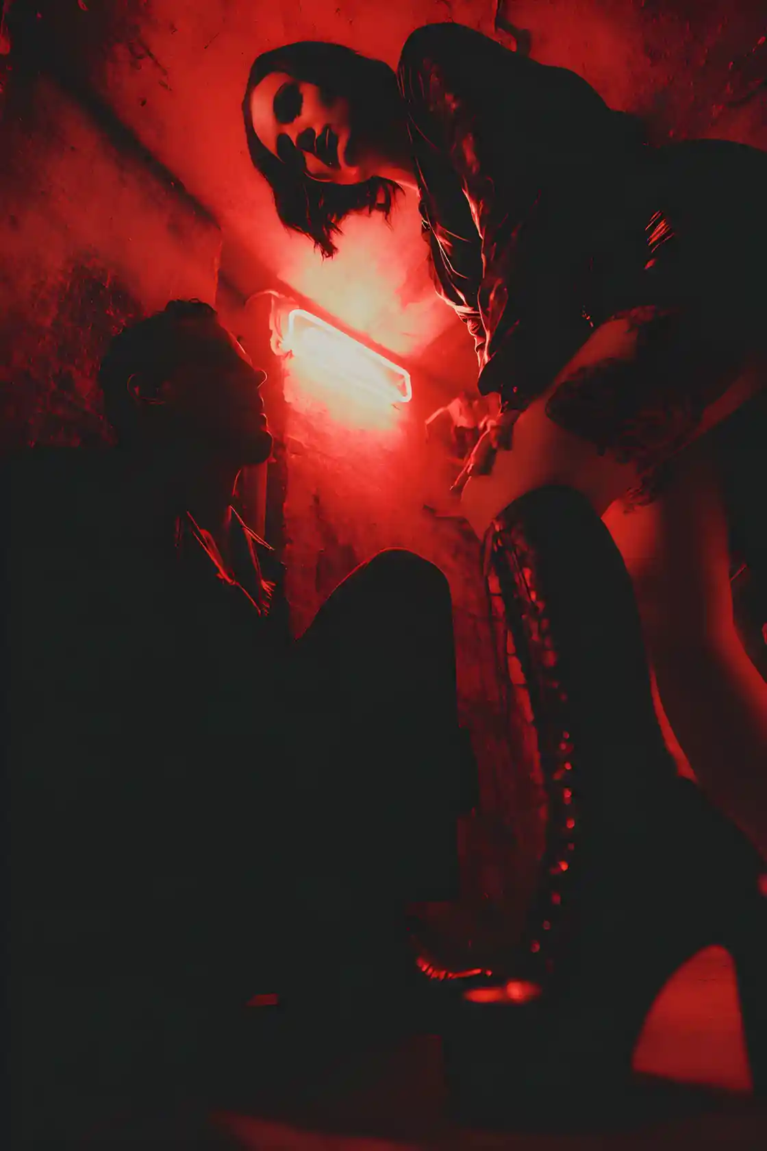 Seductive devil woman in leather in a dim dungeon