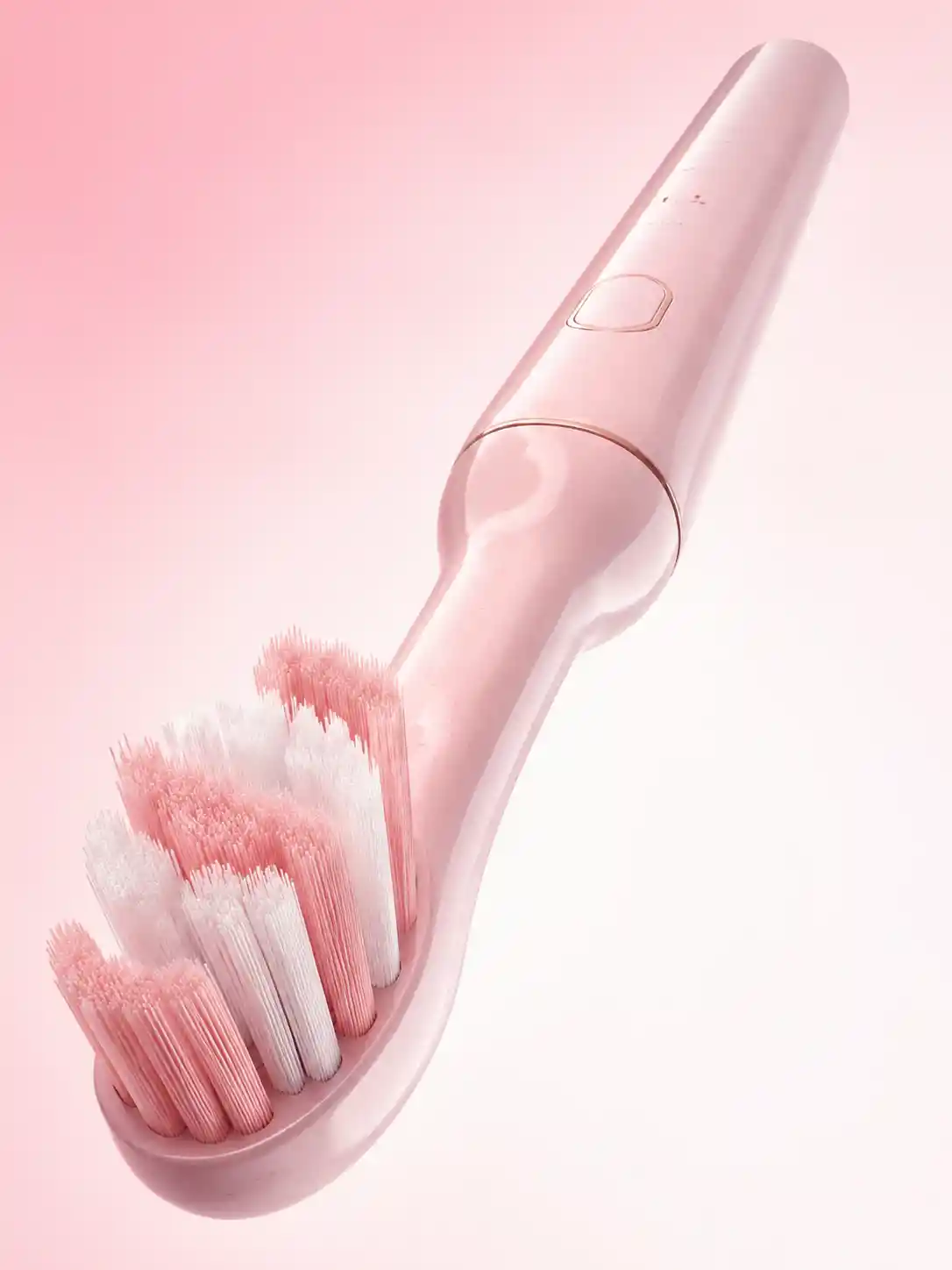 Pink electric toothbrush in extreme wide angle focus