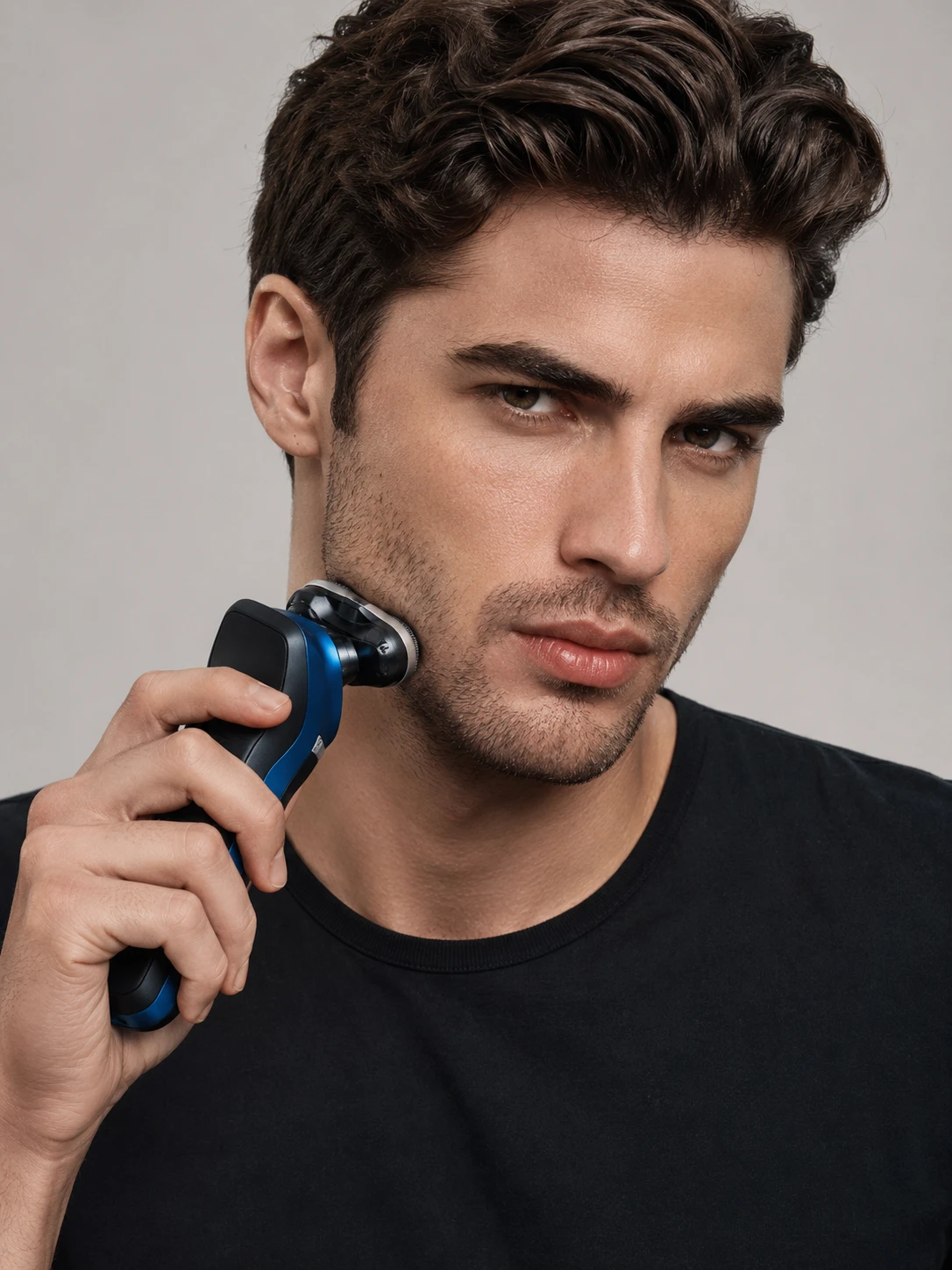 Close up male model shaving with electric razor