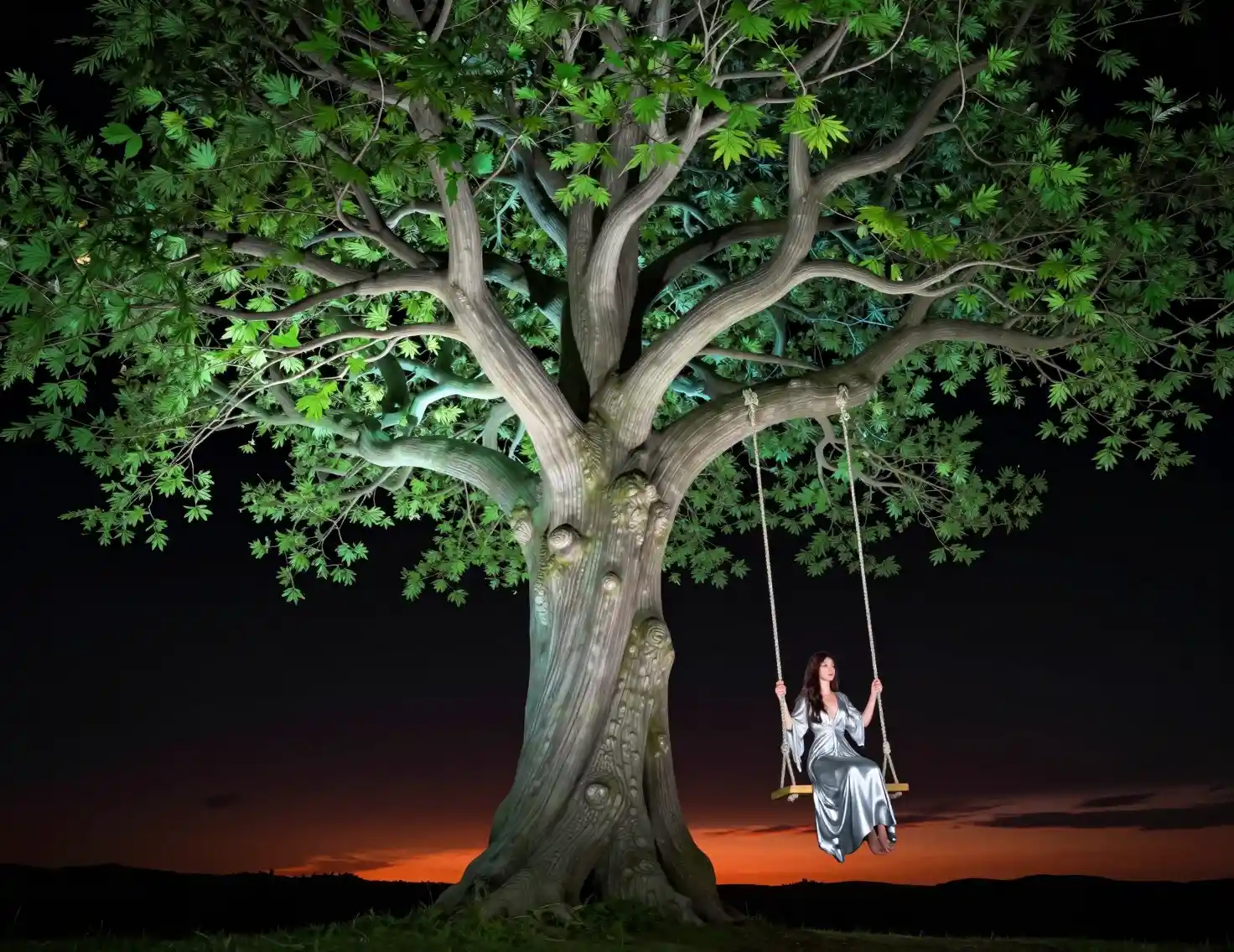 Woman on a tree swing at sunset under glowing branches