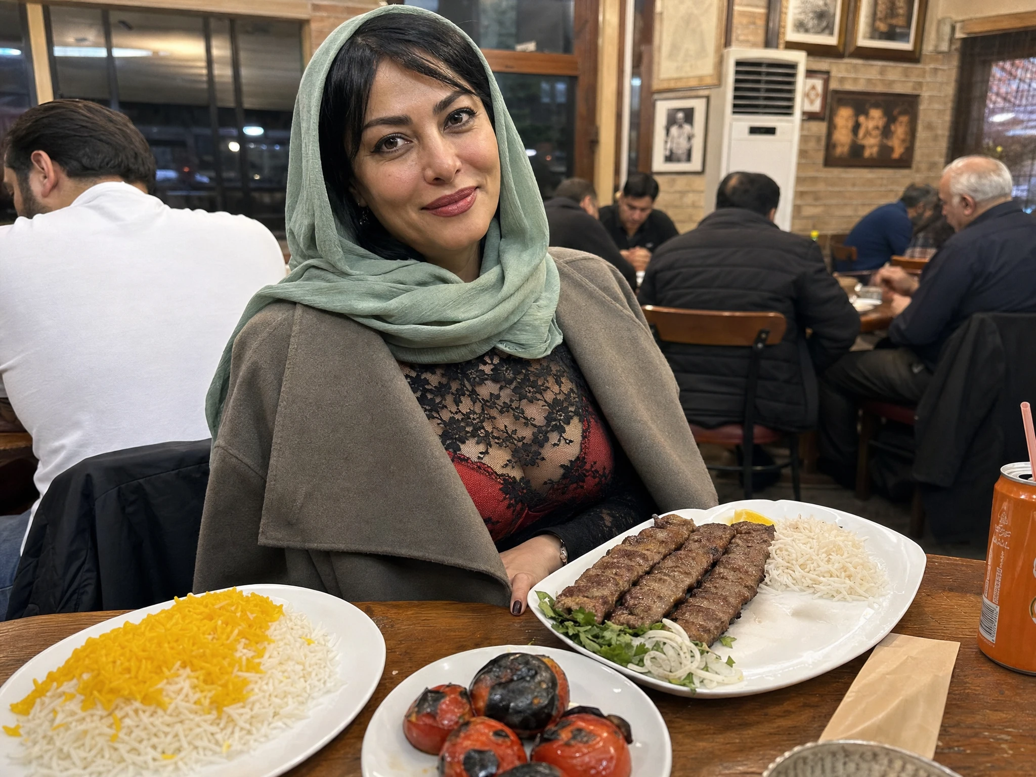 Iranian woman dining at a warm restaurant table