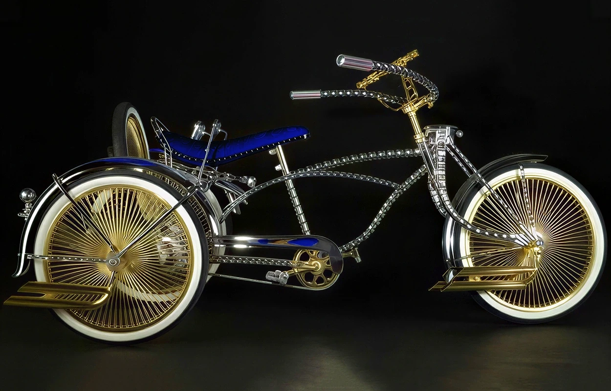 Chrome lowrider bicycle with gold details and blue seat