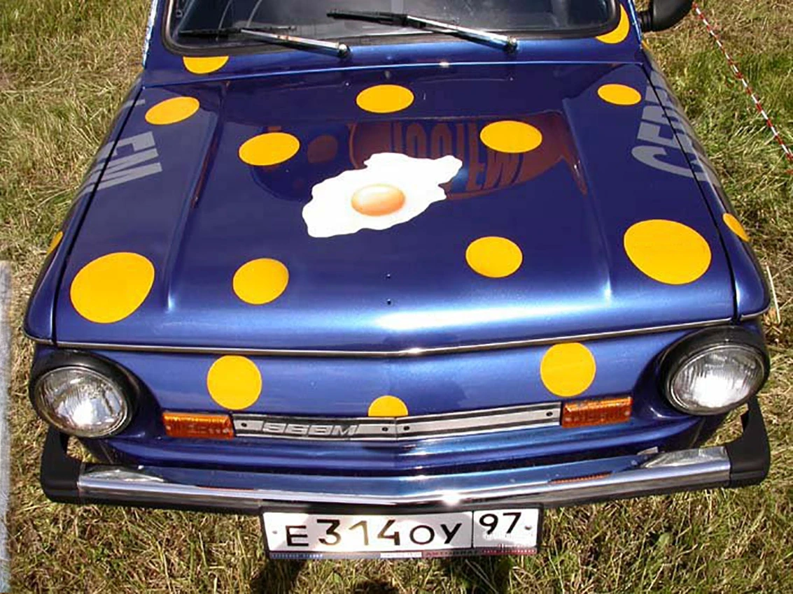 Vintage blue car with yellow polka dots and fried egg hood