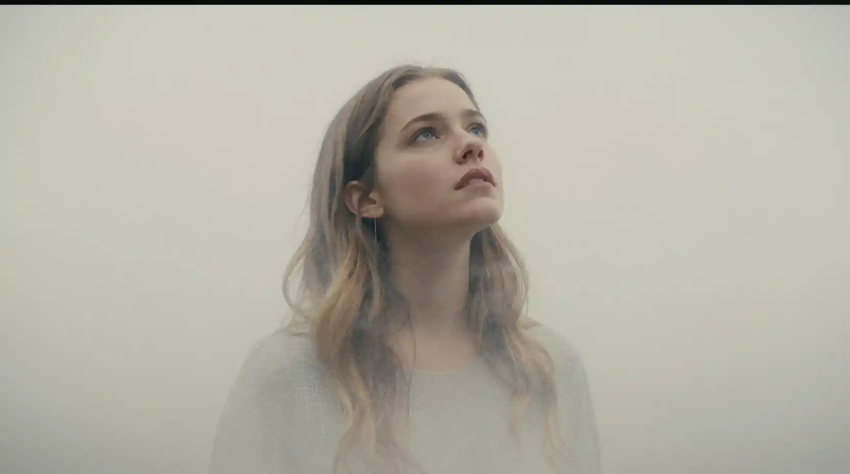 Fading young woman gazing upward in delicate hatched lines
