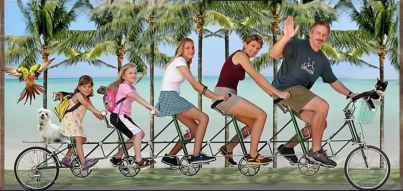 Family riding a long green tandem bike on tropical beach