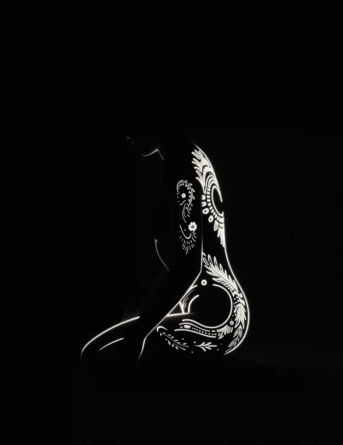 Glowing creature outlined by luminous patterns in darkness