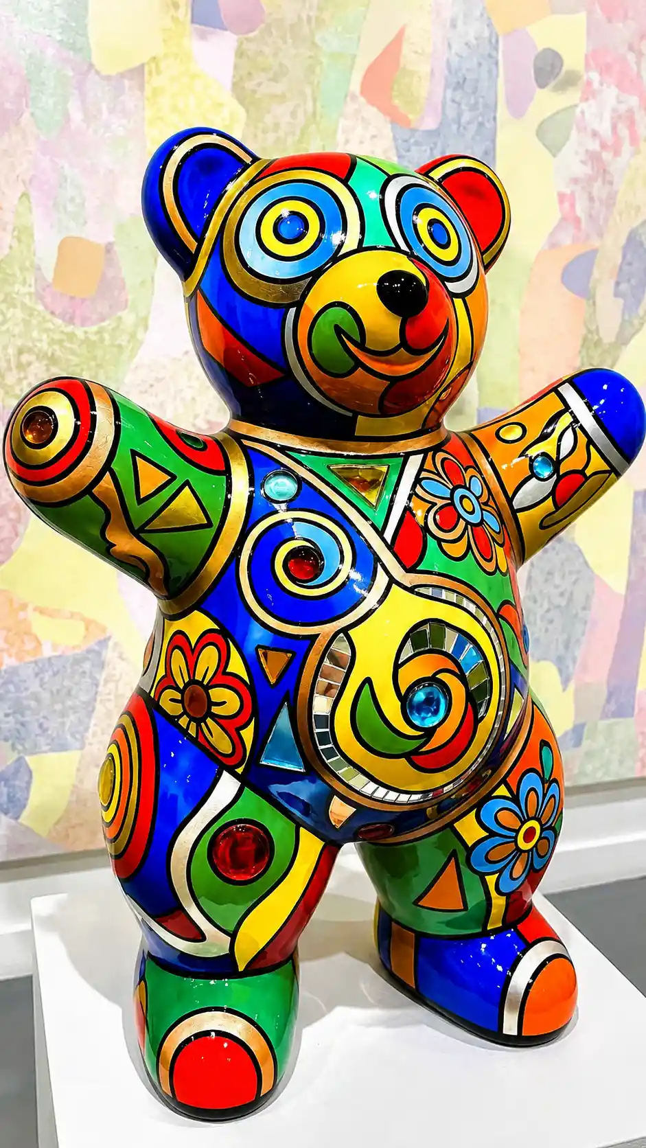 Joyful modern teddy bear sculpture with colorful abstract patterns