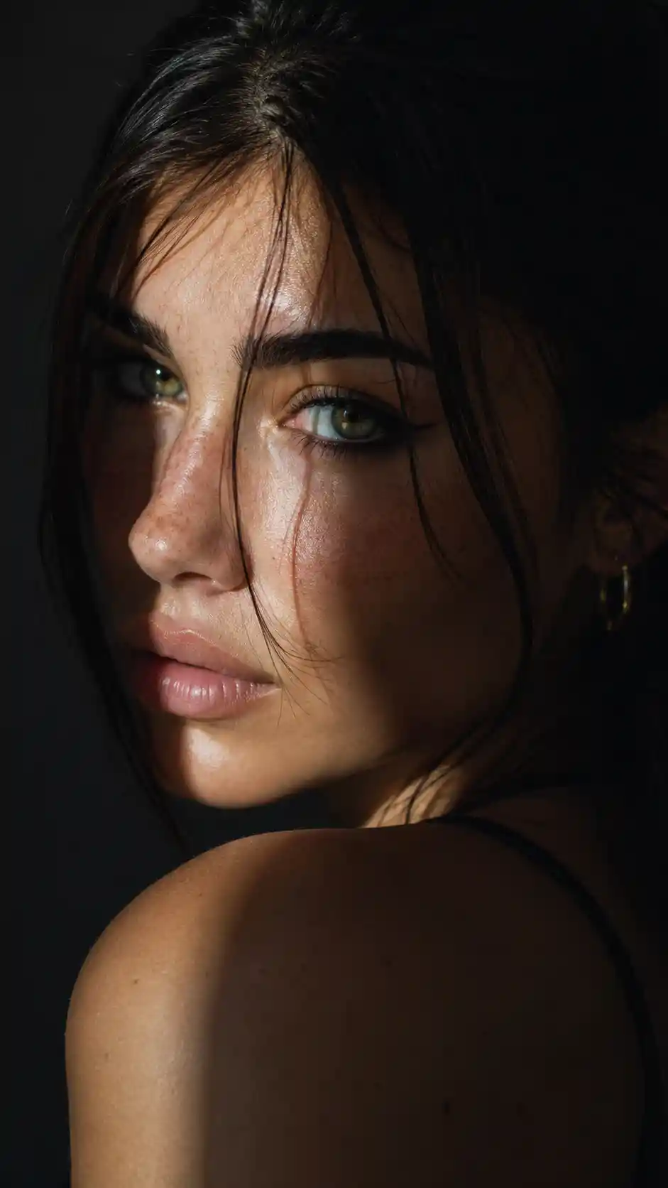 Dramatic close up portrait of a woman in shadow