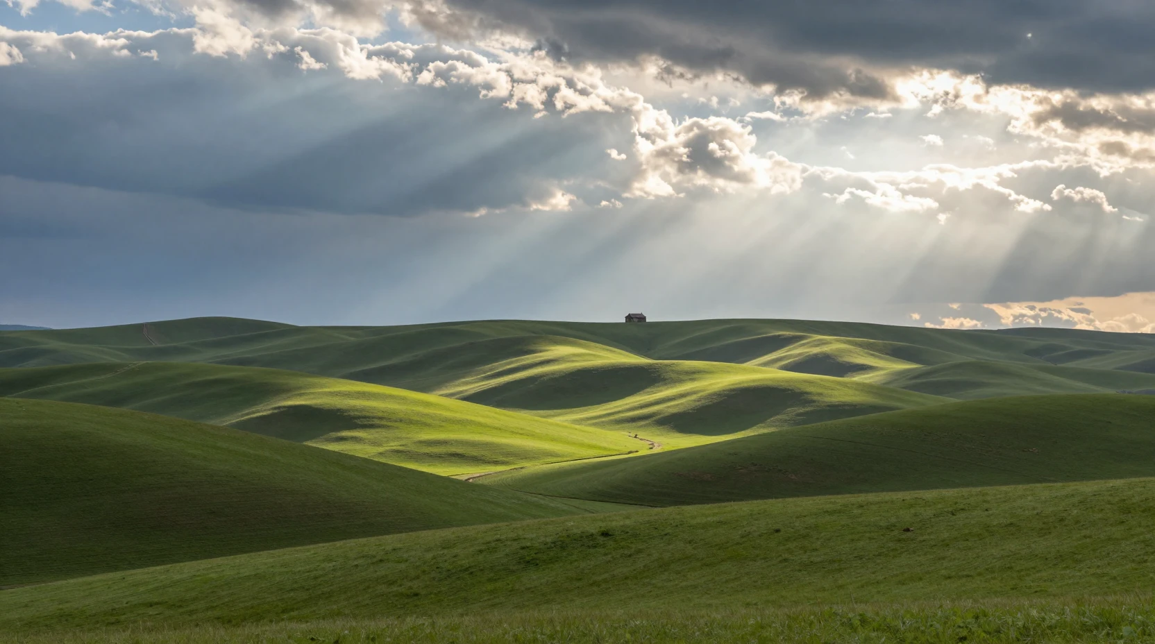 Sunlit cabin among rolling green hills under dramatic clouds