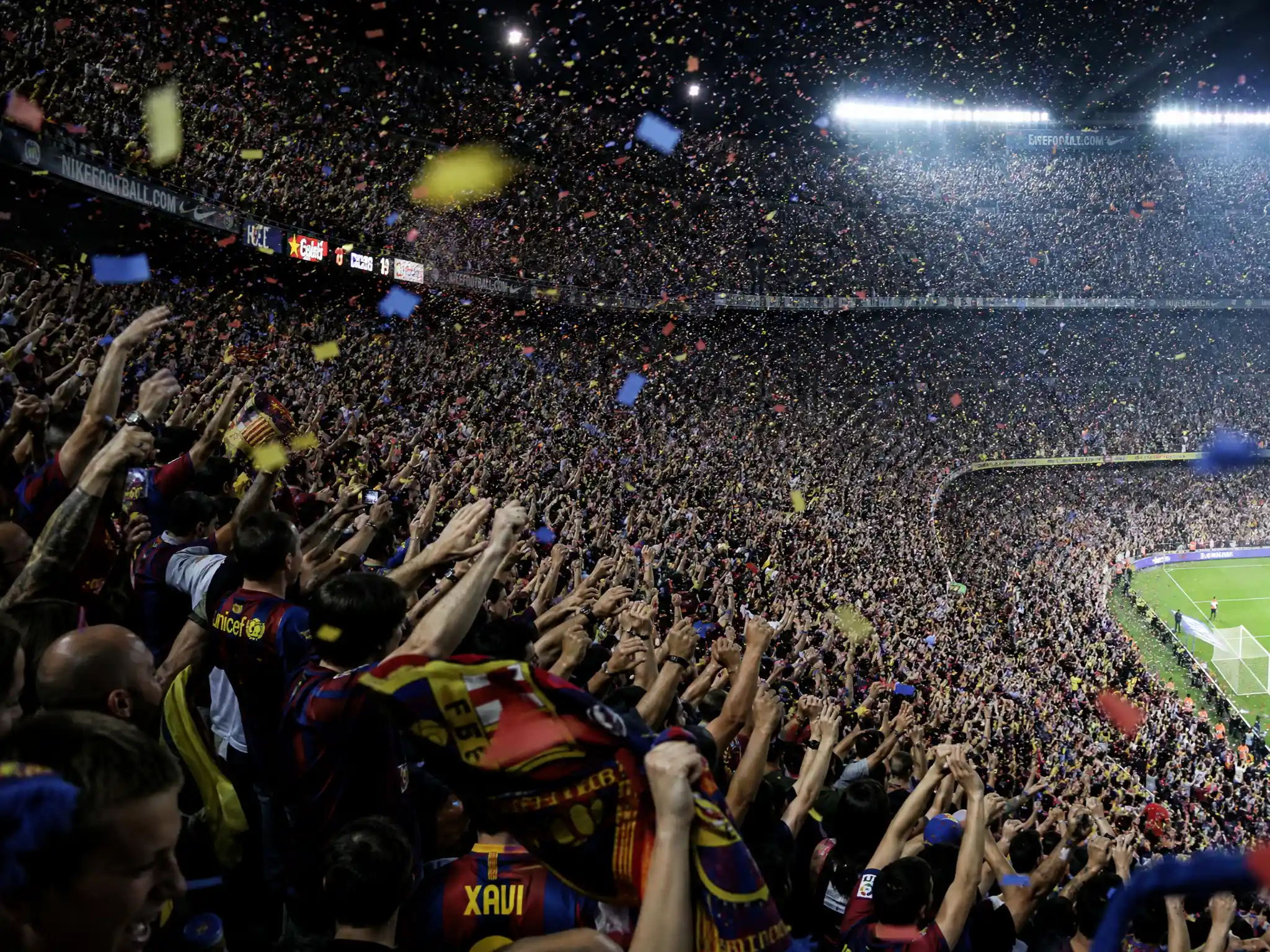 Massive football stadium crowd cheering in celebration