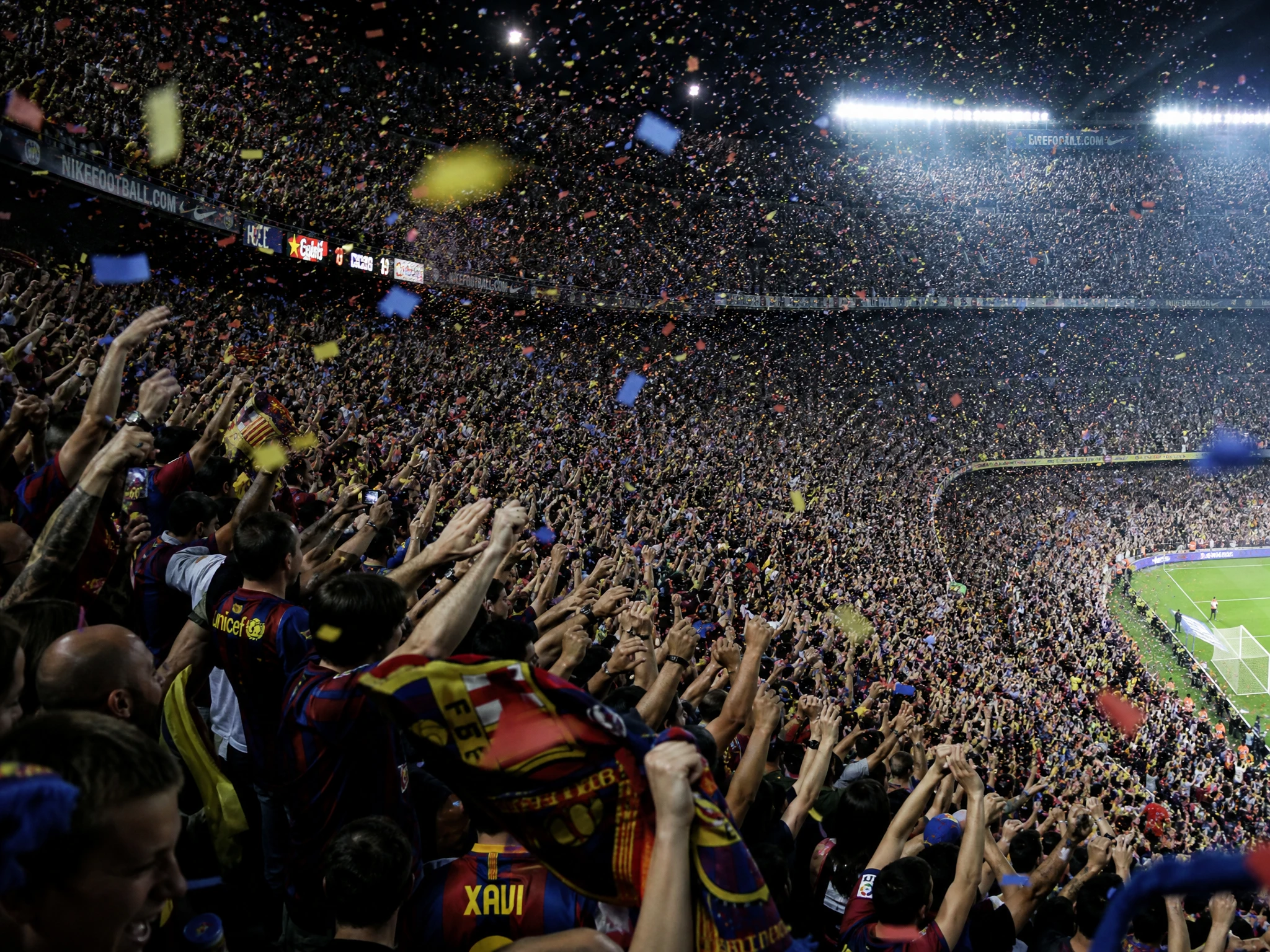 Massive football stadium crowd cheering in celebration