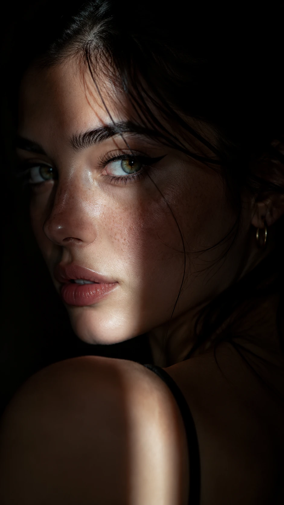 Dramatic close up portrait of a woman in split light