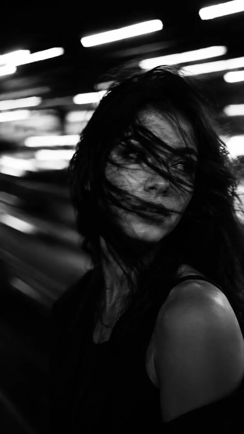 Black and white close up of a woman in blurred motion