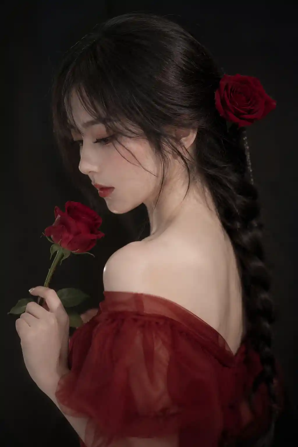 Asian woman in red dress with rose side profile portrait