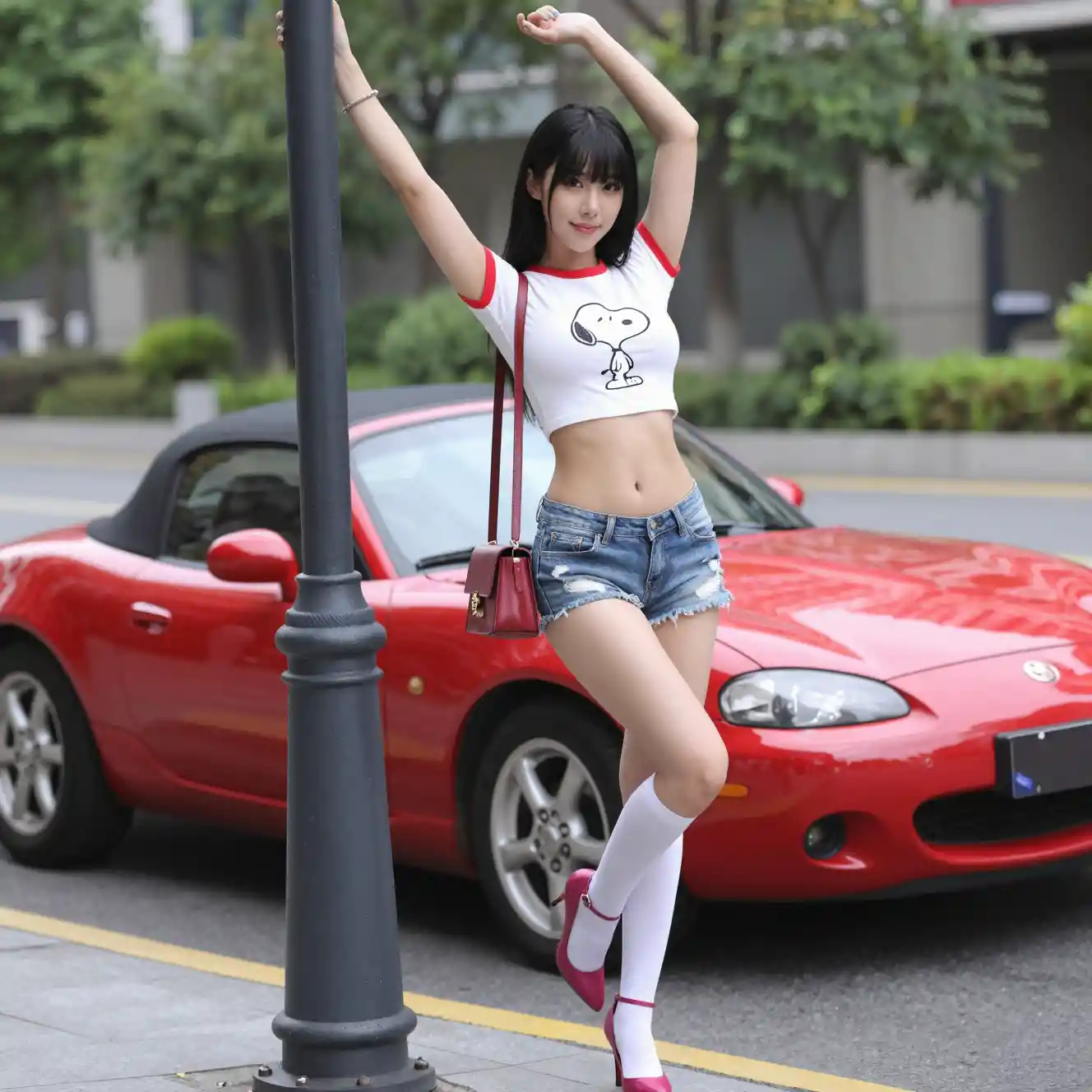 Stylish woman posing by lamp post on city street