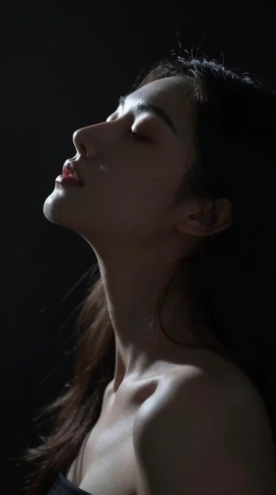 Backlit silhouette portrait of a serene young woman