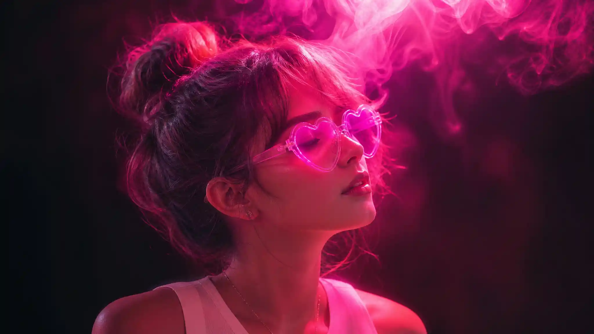 Woman in neon pink and purple light with heart glasses