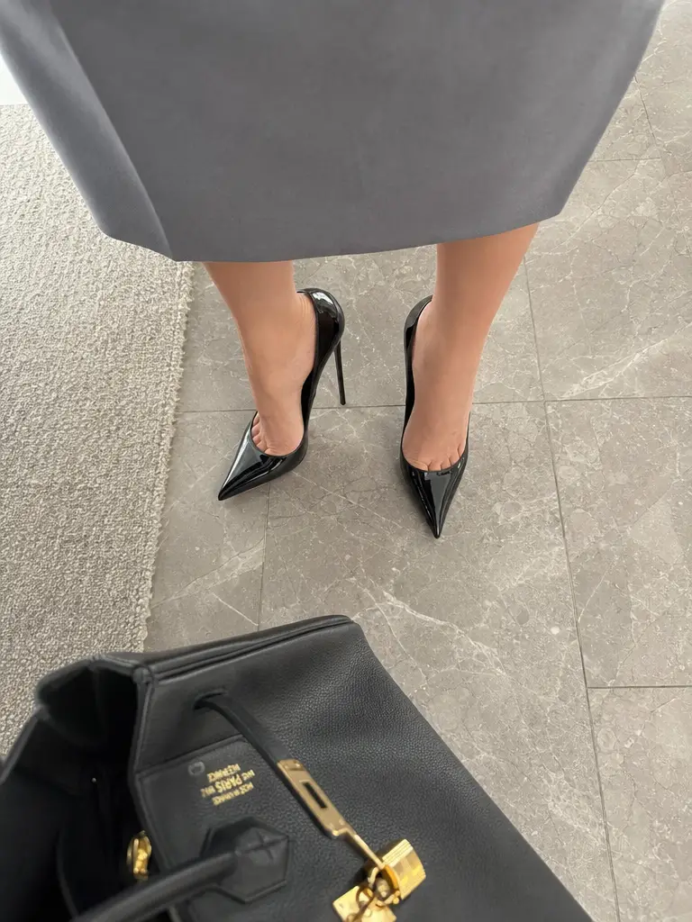 Low angle view of black high heels on indoor floor