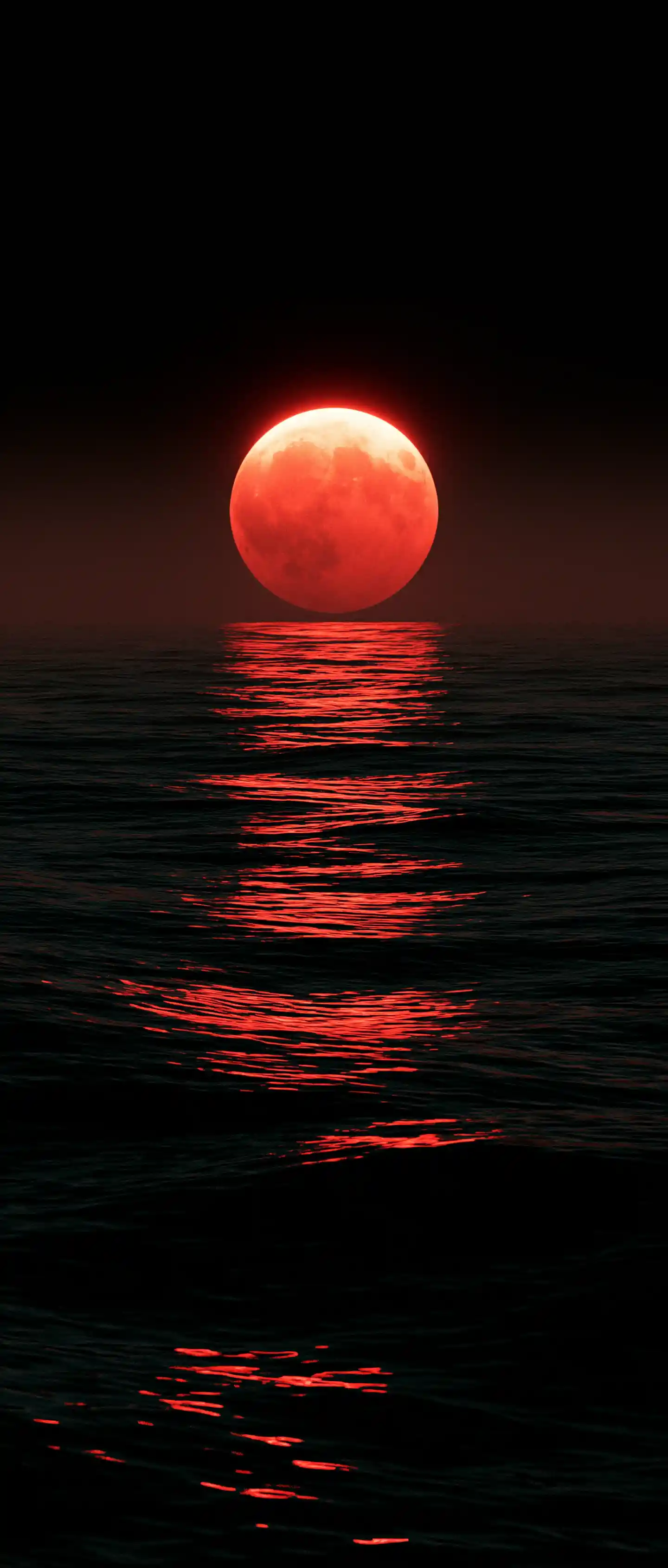 Red lunar eclipse above a dark reflective ocean
