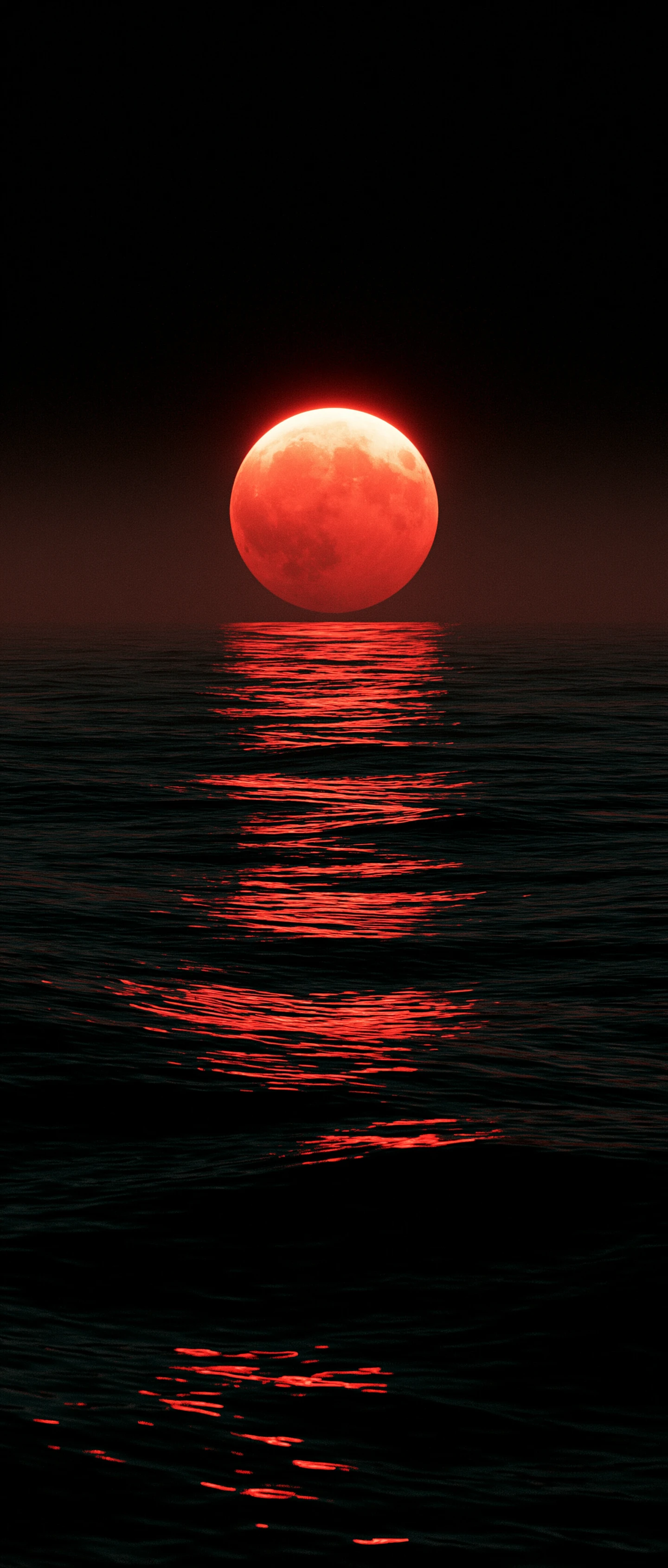 Red lunar eclipse above a dark reflective ocean