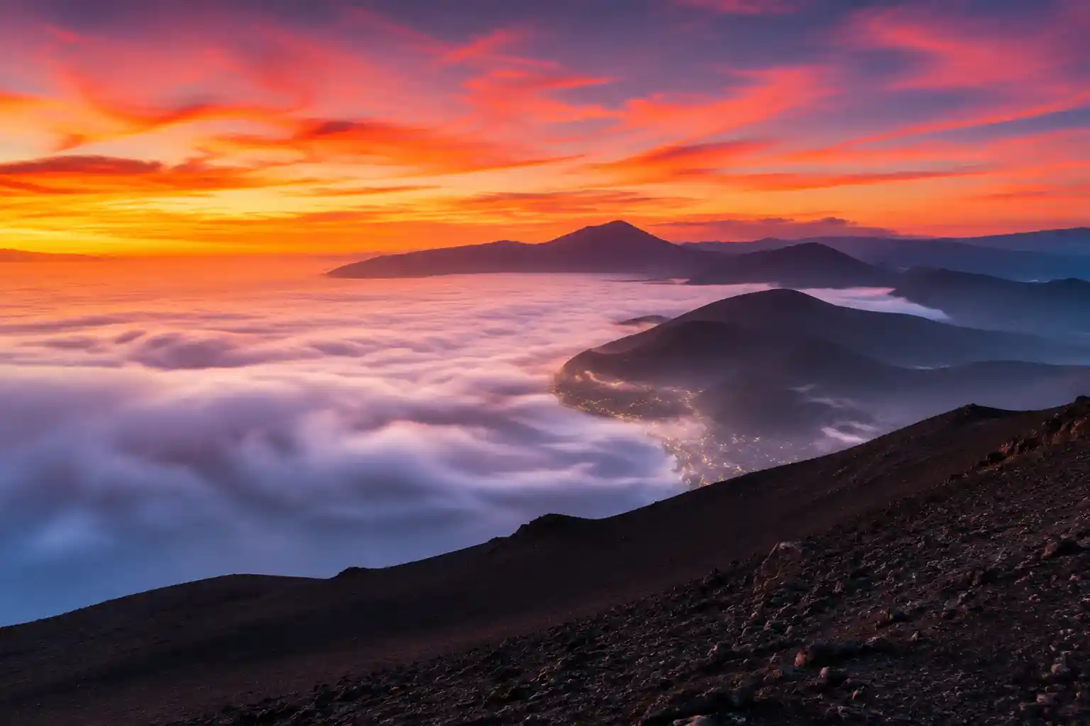 Sunrise mist over distant coastal mountain ranges