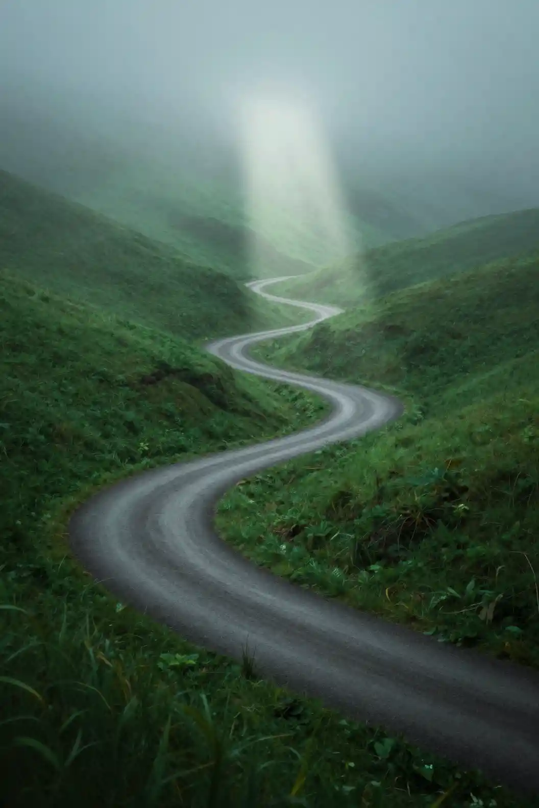 Misty Emerald Pathway Curving Through Fantastical Green Hills